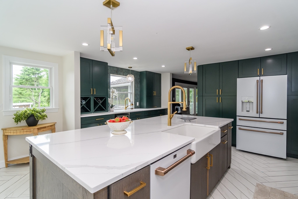 124 Everett Street Natick, MA 01760 - Photo 14 of 36 a kitchen with kitchen island a sink appliances and a large window