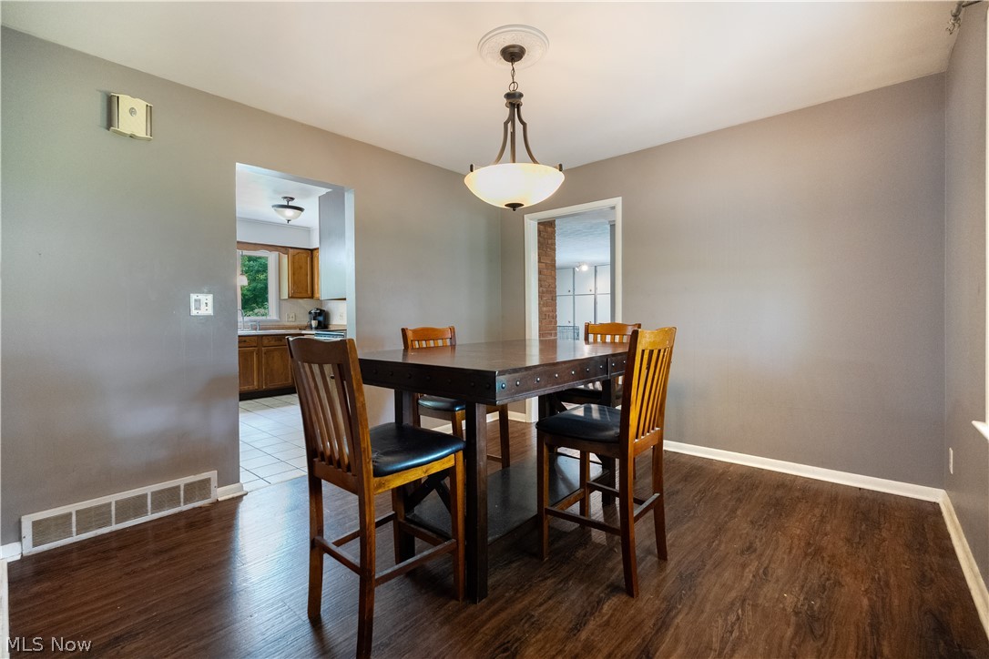 542 Garnette Road Akron, OH 44313 - Photo 5 of 24 Dining area featuring wood-finish flooring, neutral wall tones, and white baseboards