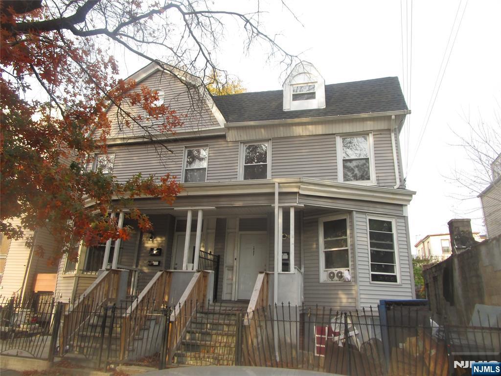 437 7th Avenue Newark, NJ 07107 - Photo 1 of 7 a front view of a house with a yard