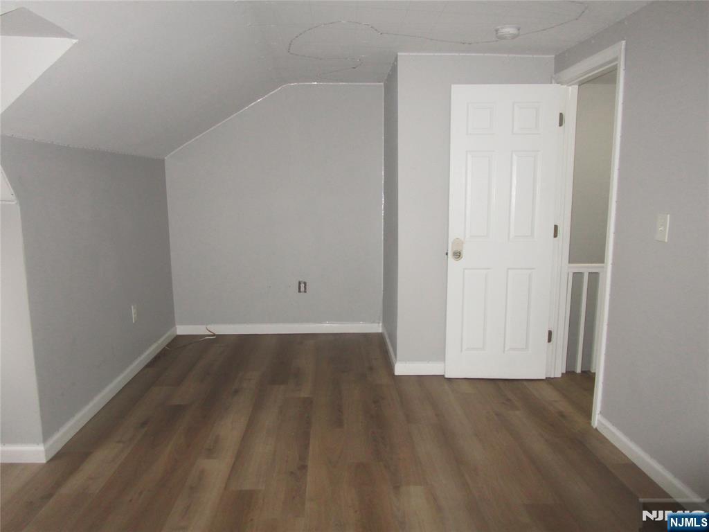 437 7th Avenue Newark, NJ 07107 - Photo 7 of 7 an empty room with wooden floor