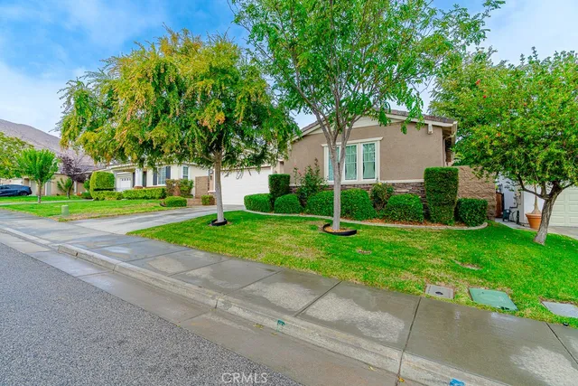 a view of a house with a yard and a street