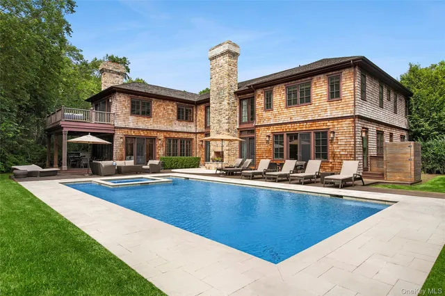 a front view of house with yard and swimming pool