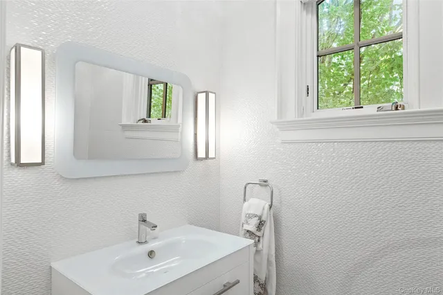 a bathroom with a toilet a sink and shower