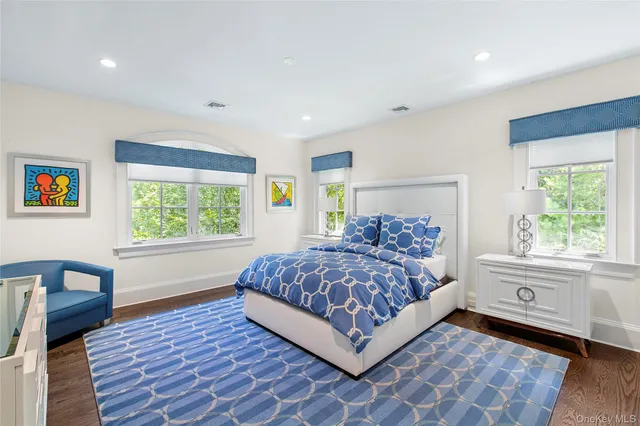 a bedroom with furniture and a flat screen tv