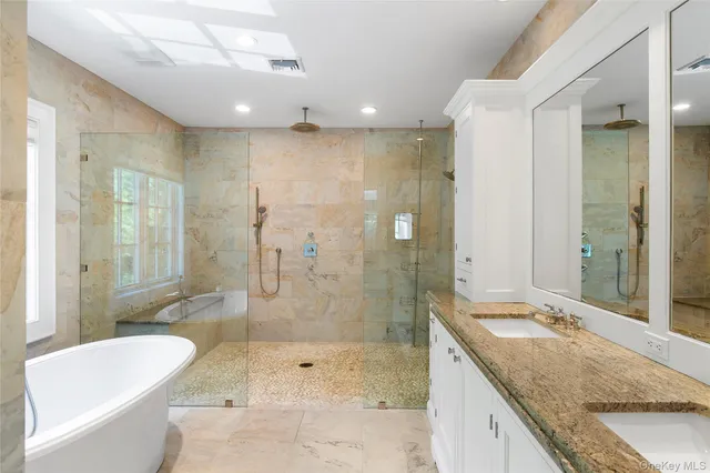 a bathroom with a granite countertop sink a toilet and shower