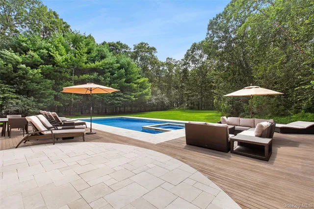 a view of a big house with a big yard and large trees