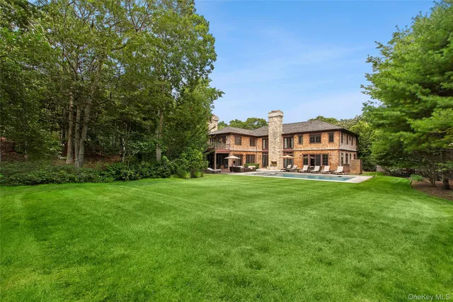 a backyard of a house with plants and large trees