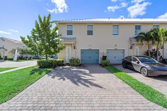 a car parked in front of a white house
