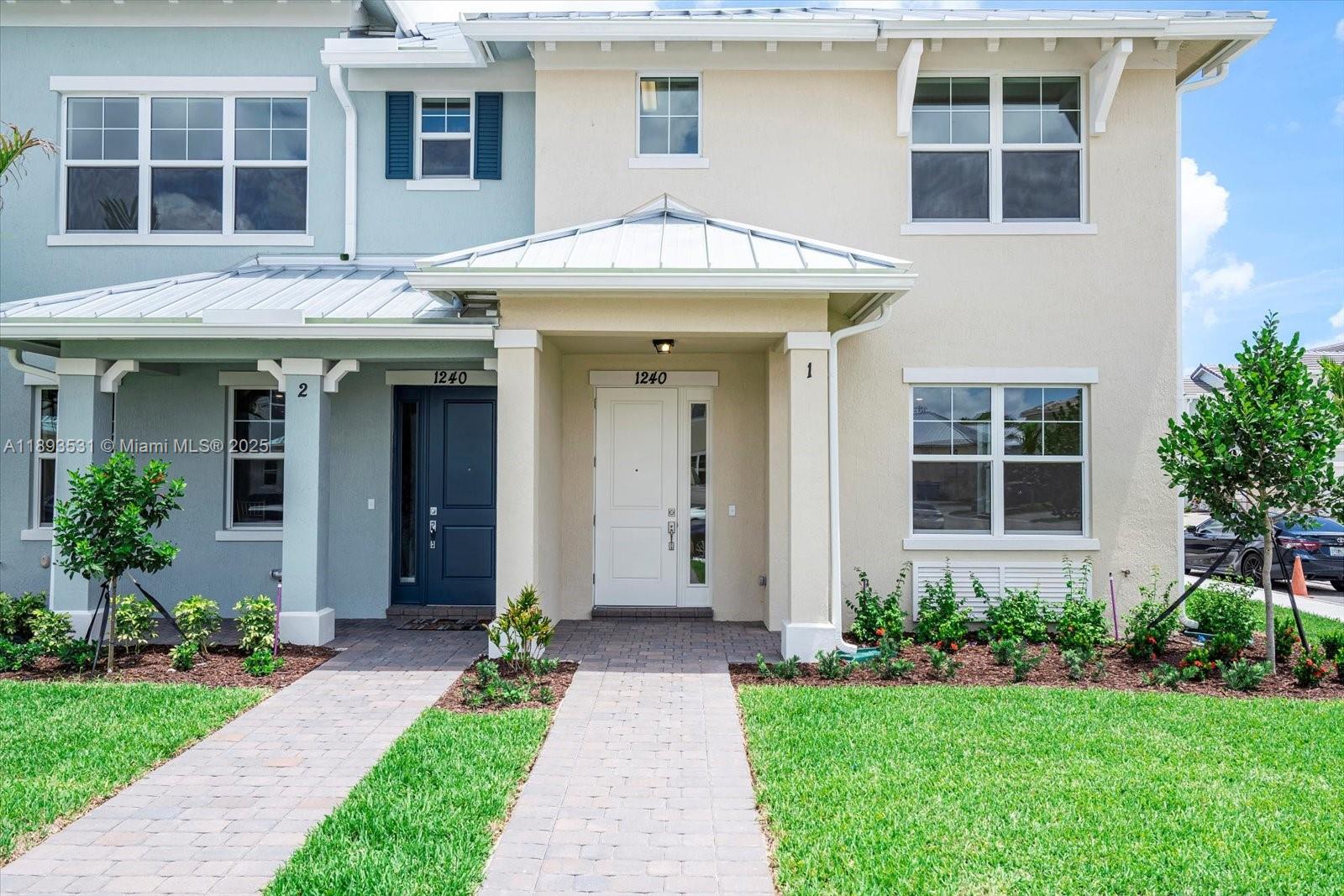 1240 Eucalyptus Drive, Unit 1 Hollywood, FL 33021 - Photo 14 of 20 a front view of a house with garden and porch