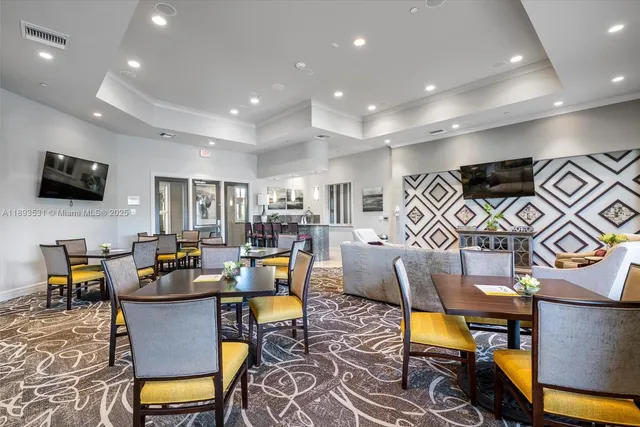 a living room with furniture kitchen view and a flat screen tv