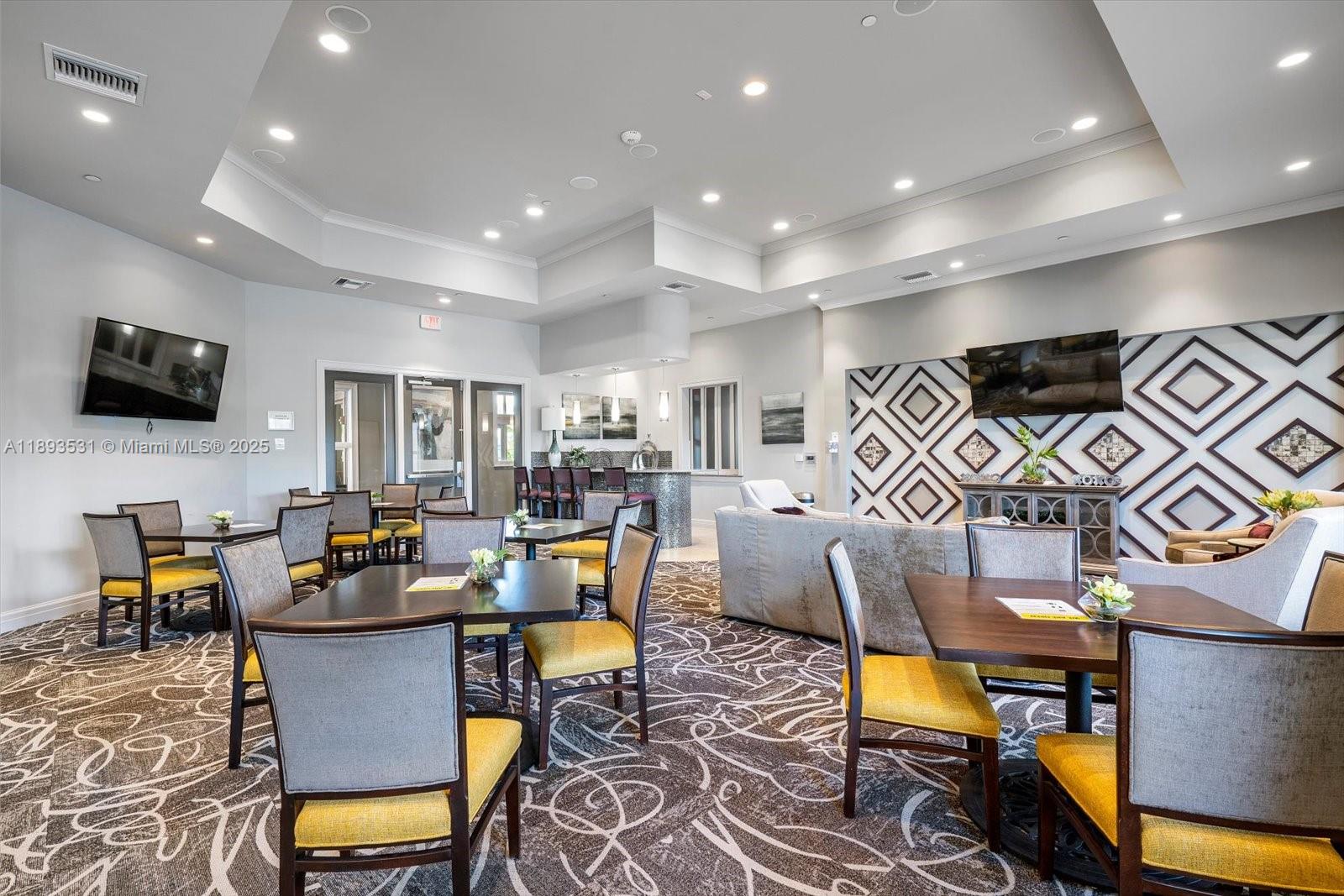 1240 Eucalyptus Drive, Unit 1 Hollywood, FL 33021 - Photo 16 of 20 a living room with furniture kitchen view and a flat screen tv