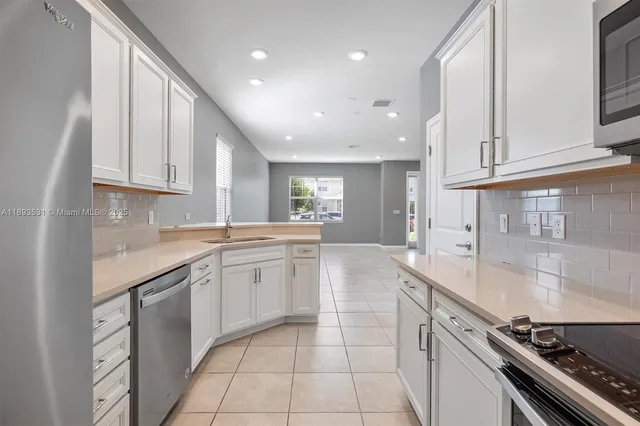 a kitchen with a sink and cabinets