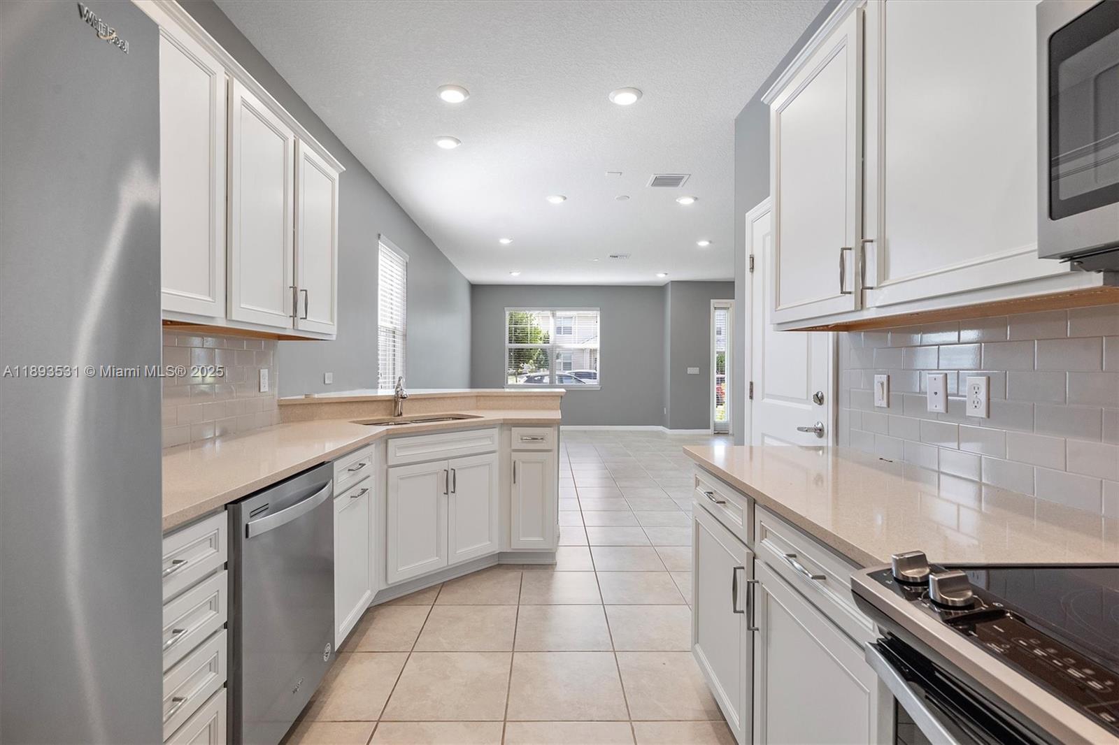 1240 Eucalyptus Drive, Unit 1 Hollywood, FL 33021 - Photo 4 of 20 a kitchen with a sink and cabinets