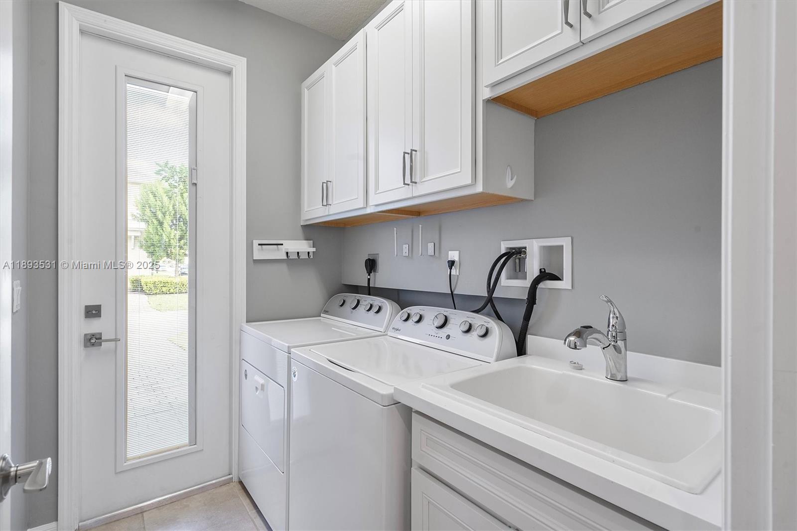 1240 Eucalyptus Drive, Unit 1 Hollywood, FL 33021 - Photo 5 of 20 a utility room with dryer and washer