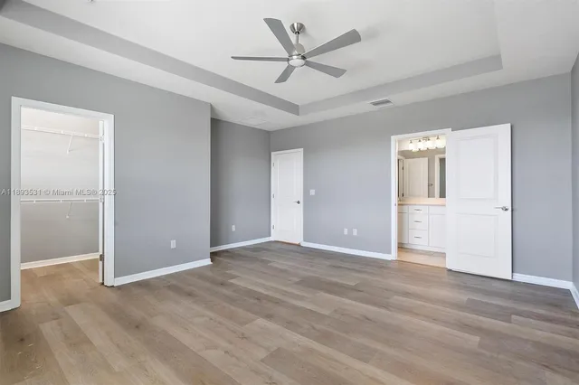 an empty room with fan and a ceiling fan