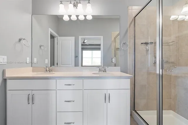 a bathroom with a sink double vanity and a mirror