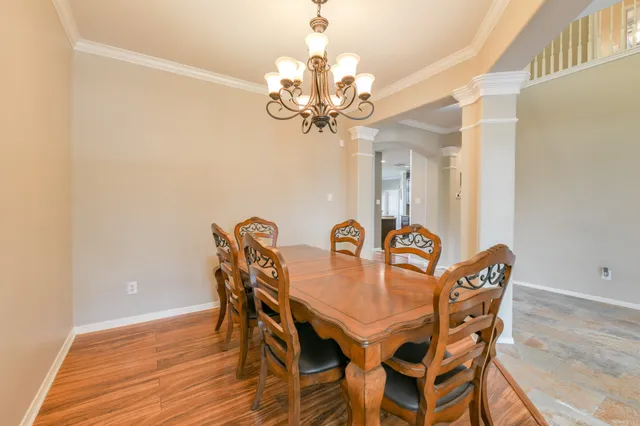 a view of a dining room with furniture and chandelier