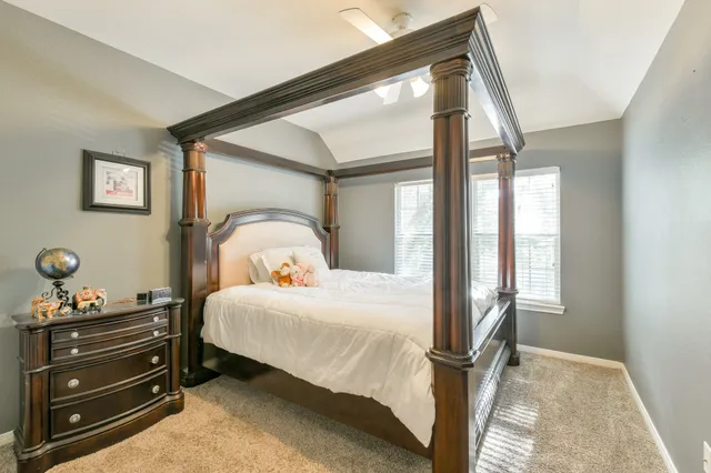 a bedroom with a bed and with windows