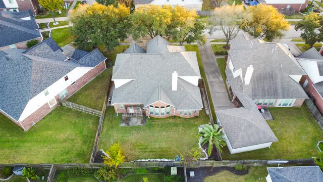 an aerial view of a house with a garden and swimming pool