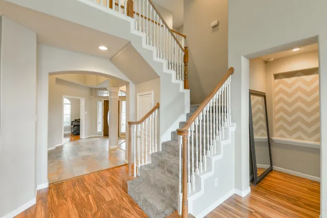 a view of entryway and hall with wooden floor