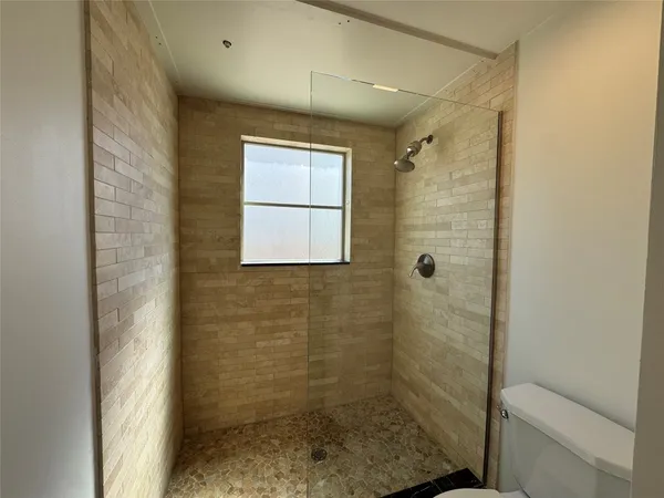 a view of a room with wooden floor and ceiling fan