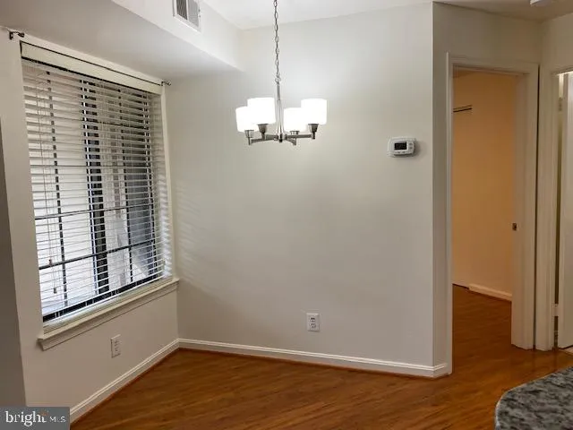 a view of a livingroom with wooden floor and a window