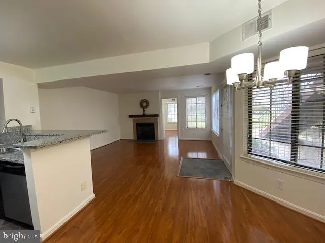 a view of kitchen and hall with wooden floor