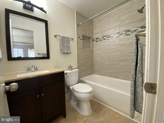 a bathroom with a toilet a sink a mirror a bathtub and vanity