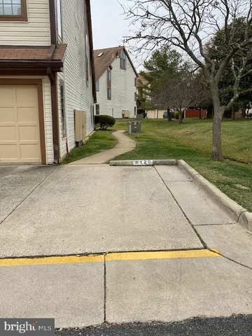 a view of a house with a yard and trees