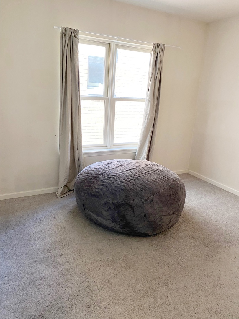 1415 South Halsted Street, Unit 3A Chicago, IL 60607 - Photo 9 of 14 a view of a bedroom with a bed and a window