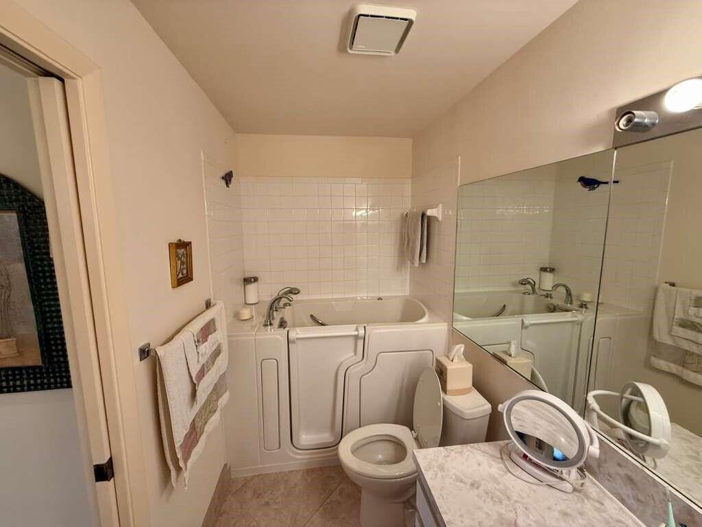 13929 Nesting Way, Unit B Delray Beach, FL 33484 - Photo 22 of 29 a bathroom with a sink a washer and dryer