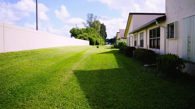 a view of a house with a backyard