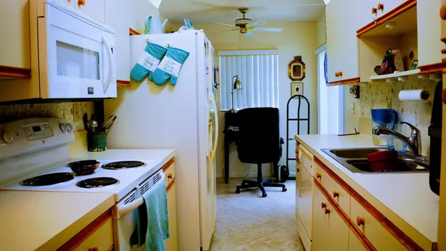 a kitchen with stainless steel appliances a stove a sink and a refrigerator