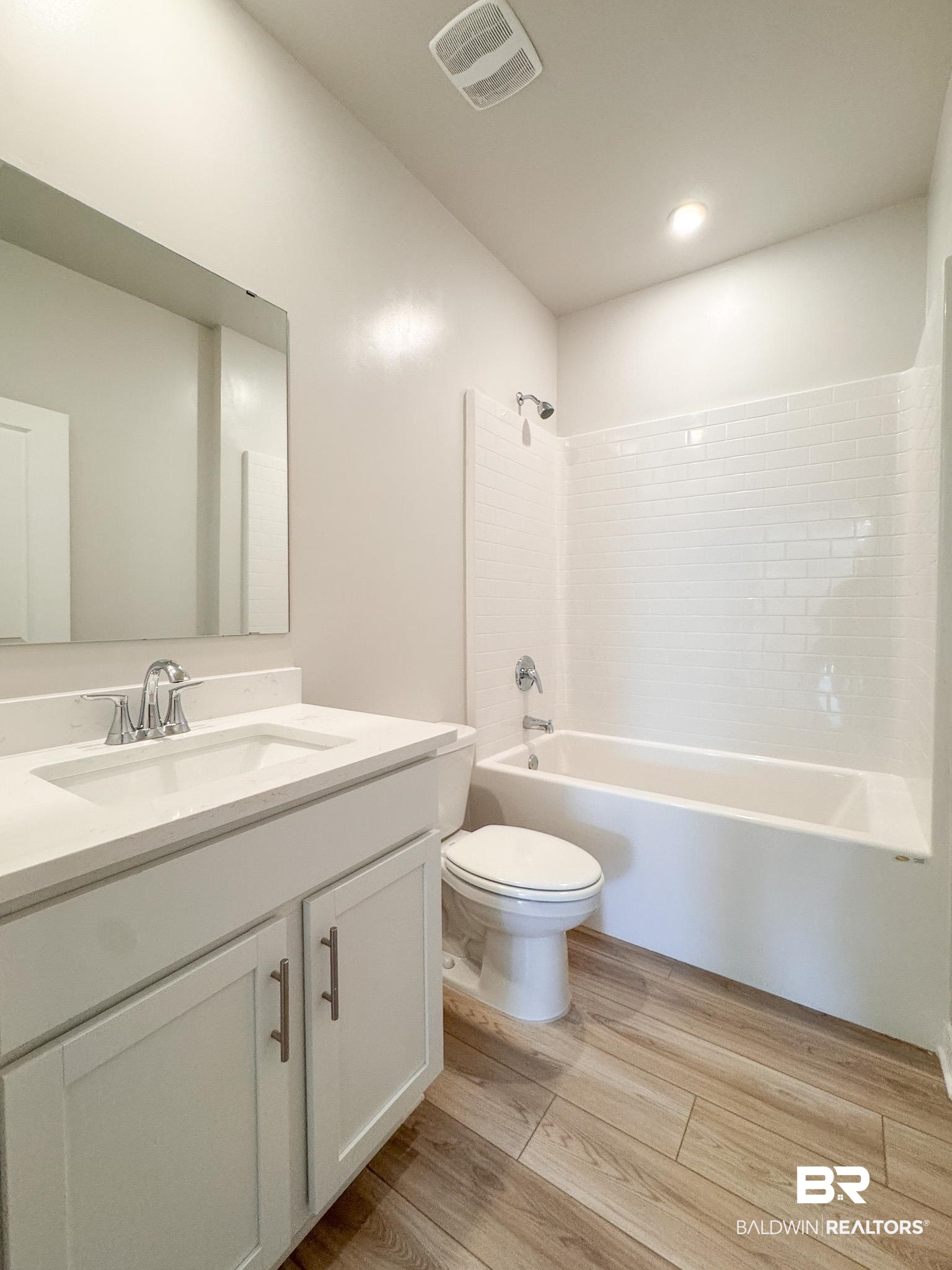 23939 Dominus Drive Daphne, AL 36526 - Photo 6 of 9 Bathroom featuring vanity, light wood-style floors, shower combination, and recessed lighting