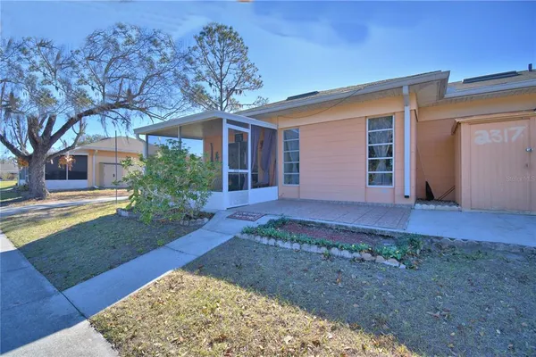 a view of a house with backyard and tree s