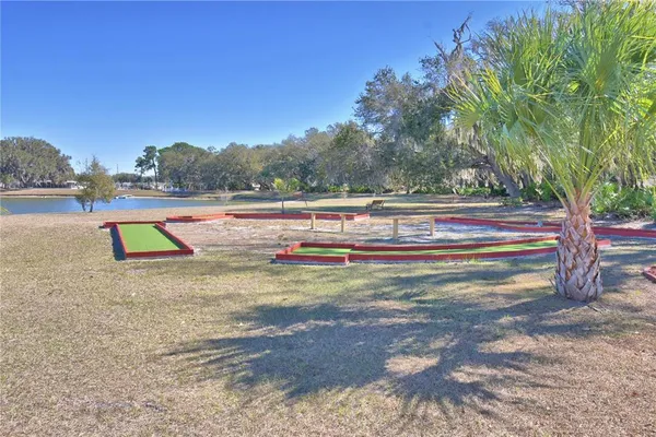 a swimming pool with outdoor seating and yard
