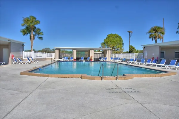 a view of swimming pool with outdoor seating