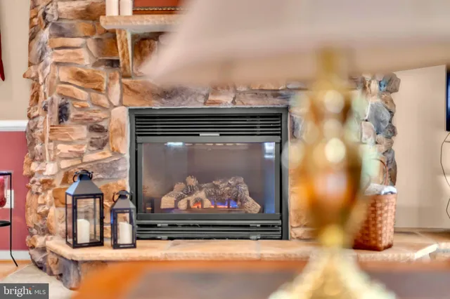 a kitchen with stainless steel appliances granite countertop a dining table chairs and refrigerator