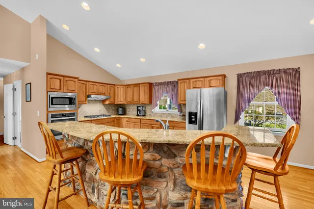 a dining room with furniture a chandelier and wooden floor