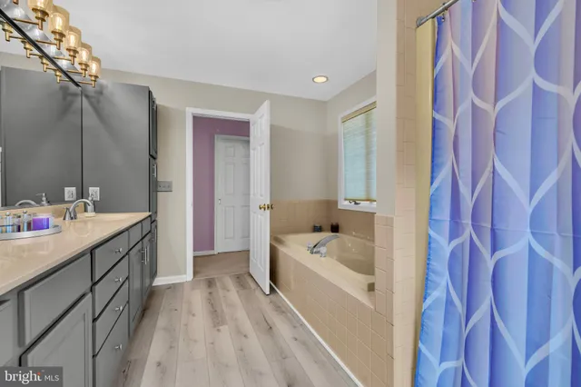 a bedroom with a bed and a ceiling fan