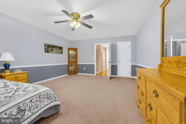 a bathroom with a granite countertop sink a mirror a vanity and a shower
