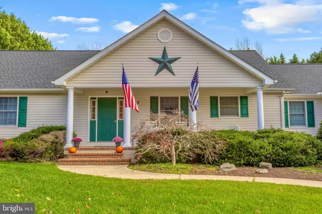 an aerial view of a house with yard swimming pool and outdoor seating
