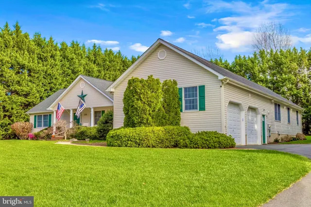 an aerial view of a house with a yard basket ball court and outdoor seating
