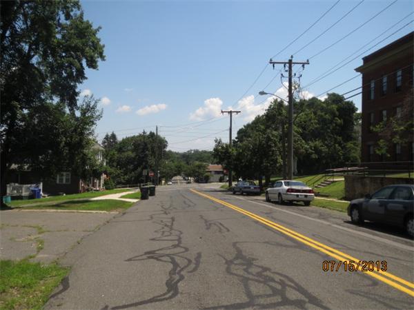 1134 Worcester Street Springfield, MA 01151 - Photo 14 of 14 a view of a road with a bench and trees