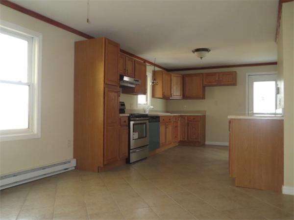 1134 Worcester Street Springfield, MA 01151 - Photo 3 of 14 a kitchen with stainless steel appliances granite countertop a stove a sink and a refrigerator