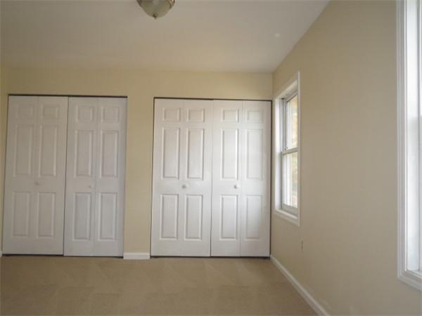 1134 Worcester Street Springfield, MA 01151 - Photo 6 of 14 an empty room with wooden floor and cabinet