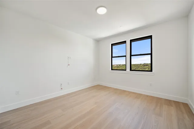 a view of an empty room with windows and a balcony