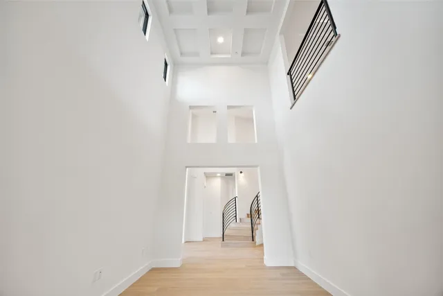 a view of a hallway with a white door and a window