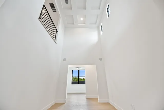 an empty room with windows and closet