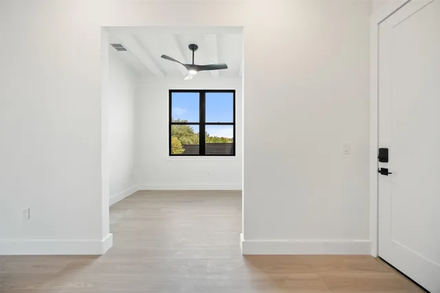 a view of a hallway with wooden floor